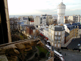 View of the Parisian district of Montmartre with gothic chimera from the windows of The Basilica of...