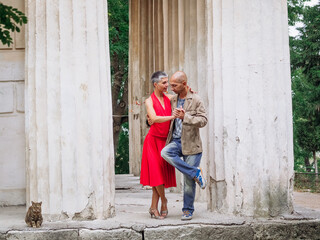 Tango nuevo dance - the famous partner dance with a woman in a red dress with the vibrant & playful style of movement, rich expressions, improvisation and close connection and passion between dancers