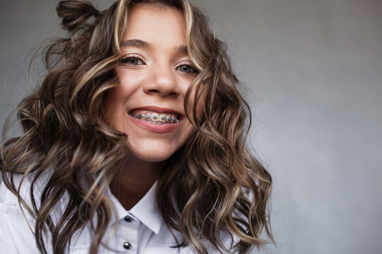 Portrait of beautiful girl teenage with light make-up.The gitl is smiling in braces