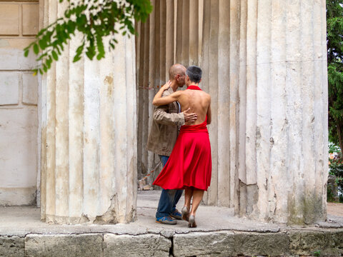 Tango nuevo dance - the famous partner dance with a woman in a red dress with the vibrant & playful style of movement, rich expressions, improvisation and close connection and passion between dancers