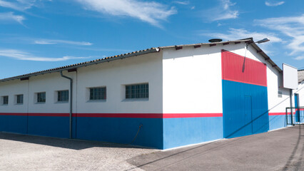 Puerta metálica roja y azul en nave industrial