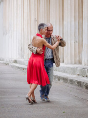 Tango nuevo dance - the famous partner dance with a woman in a red dress with the vibrant & playful style of movement, rich expressions, improvisation and close connection and passion between dancers