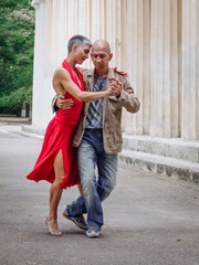 Tango nuevo dance - the famous partner dance with a woman in a red dress with the vibrant & playful...
