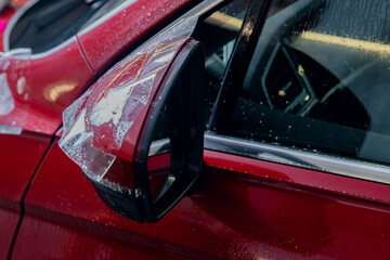 Fototapeta premium Installs vinyl film for protect paint body side mirrors red car