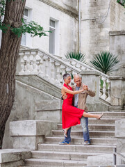Tango nuevo dance - the famous partner dance with a woman in a red dress with the vibrant & playful...