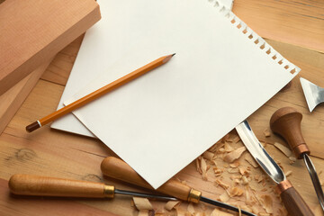 Mockup blank sheet of paper with a pencil on wooden craftsman desk. Furniture ideas illustration,...