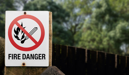 A keep out sign on a countryside tourist trail showing that it is forbidden to light any kind of fire. Prohibition to light fires in public places fire risk.