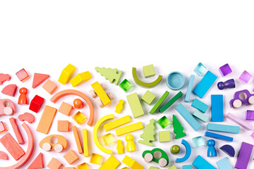 Colorful abstract background with wooden toys. Educational games for Colors sorting. Rainbow colored toys on white background.  Developing Montessori toddlers activities.