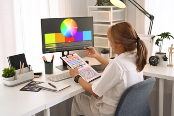 Creative woman working with color palette, choosing color samples for design project at modern...