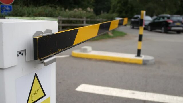 Car vehicle barrier gate closing at an entrance access to car park parking lot
