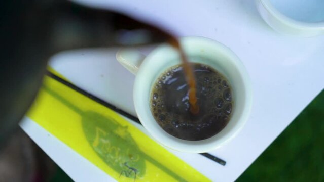 Pouring Ethiopian coffee in a cup, Addis Ababa, Ethiopia