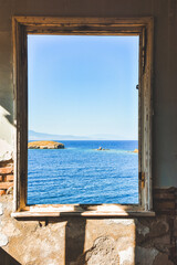 Window to the sea in an abandoned house and across the islands, the Aegean sea, Foça, Phokai, IzmirTurkey