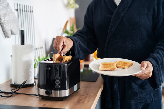 Part of senior caucasian man preparing breakfast at home