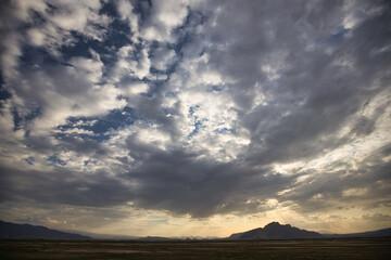 clouds and mountains in the sky just after sunset