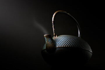 Chinese metal teapot at a low angle with slight steam fine art