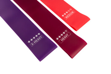 fitness elastic band. Woman showing a blue rubber band. Sport and healthy active lifestyle concept. A set of colorful elastic fitness band. 