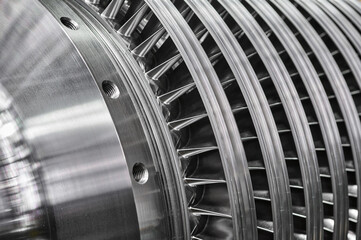 Large steam turbine with shiny blades and holes at plant