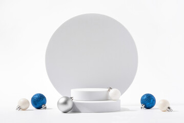 Cosmetic background for Christmas and winter holiday. White podium, christmas balls and snow on...