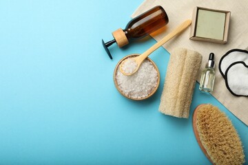 Flat lay composition with eco friendly products on light blue background, space for text