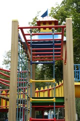 Children's playground with climbing rope ladder on summer day
