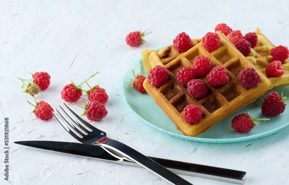 Poster stack of baked belgian waffles with ripe red raspberry