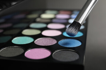 Colorful eyeshadow palette with brush, closeup view