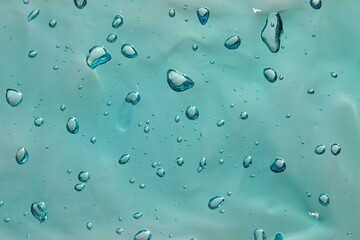 Turquoise facial gel as background, closeup view