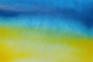 Abstract picture drawn by blue and yellow spray paints as background, closeup