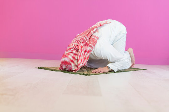 Young muslim man praying salat during Ramadan