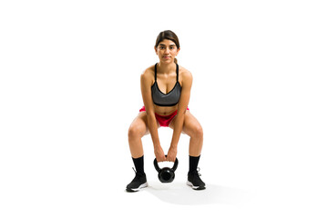 Gorgeous young woman doing weight lifting with a kettlebell