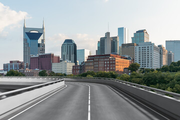 Fototapeta na wymiar Empty urban asphalt road exterior with city buildings background. New modern highway concrete construction. Concept of way to success. Transportation logistic industry fast delivery. Nashville. USA.