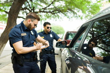 Police agents talking with a driver about his speeding ticket
