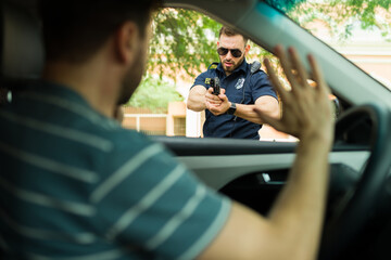 Angry cop trying to arrest a male driver using a gun