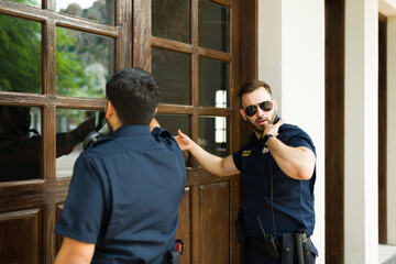 Police agents knocking on the door to do a criminal investigation