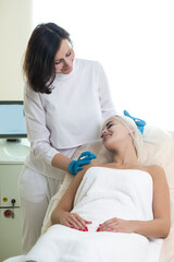 Caucasian Woman During Facial Beauty Treatment While Preparing for Pigmentation Removal by Using Facial Pencil Markup Liner at Cosmetic Clinic Prior to Intense Pulsed Light Therapy IPL.