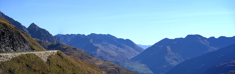 Beautiful wide angle mountain panorama at summit of Swiss mountain pass Furkapass with Ursern Valley on a sunny late summer day. Photo taken September 12th, 2022, Furka Pass, Switzerland.