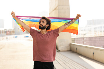 Happy man with a pride flag. LGBT community