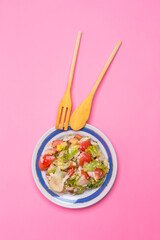 Vegetables Organic Salad With Mixture of Fresh Green Cabbage Leaves and Juicy Tomatoes With Oil Dressing as Helthy Food concepts On Pink With Wooden Set.