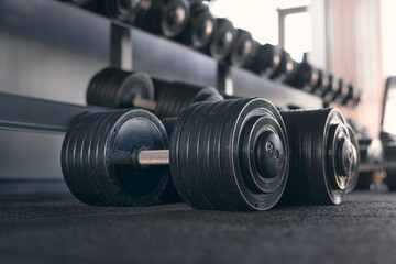 Fototapeta premium Rows of dumbbells in the gym Close up of modern dumbbells equipment in the sport gym, gym equipment concept