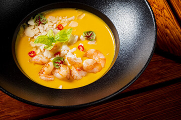 pumpkin soup with shrimps and herbs