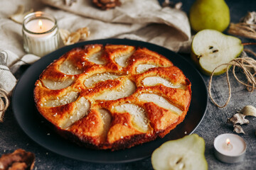 Cake with pear, honey and almonds. Delicious pie on a concrete table