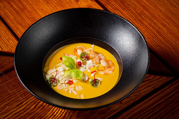 pumpkin soup with shrimps and herbs