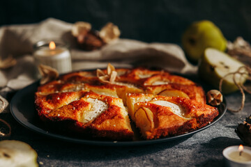 Cake with pear, honey and almonds. Delicious pie on a concrete table