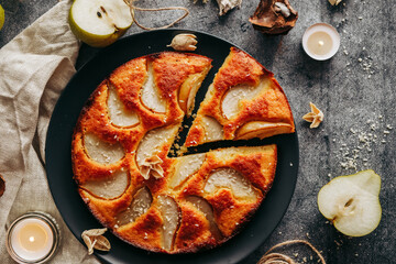 Cake with pear, honey and almonds. Delicious pie on a concrete table