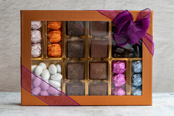 Packed gift chocolate. Packed chocolates on gray background. close up