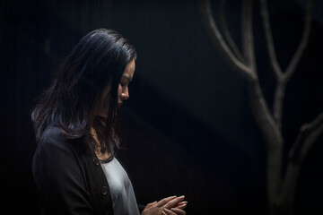 Woman looking down at hands