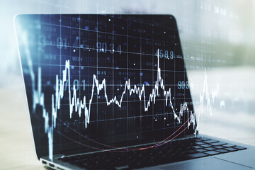 Abstract creative financial graph on modern laptop background, forex and investment concept. Multiexposure