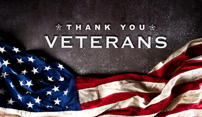 Fototapeta na wymiar Happy Veterans Day concept. American flags against a dark stone background. November 11.