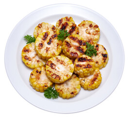 Grilled Slices of corn cobs with stripes from a grill in ceramic plate
