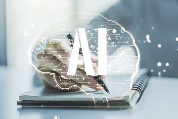 Creative artificial Intelligence concept with human brain sketch and man hand writing in diary on...